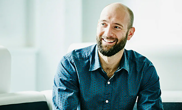 man in blue shirt smiling